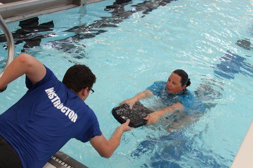 Instructor teaching swim lesson in Hall Aquatic Center Pool