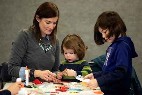 Mother and two children creating a craft at Harriet E. Brown Community Center