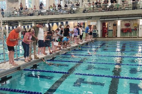 Parent volunteers timing at swim meet