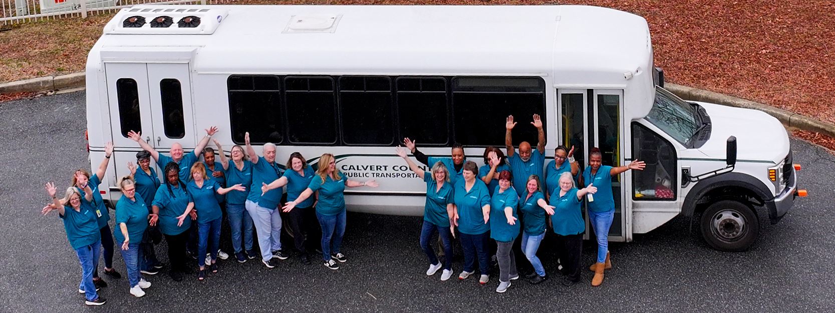 Group of transportation staff in front of a bus