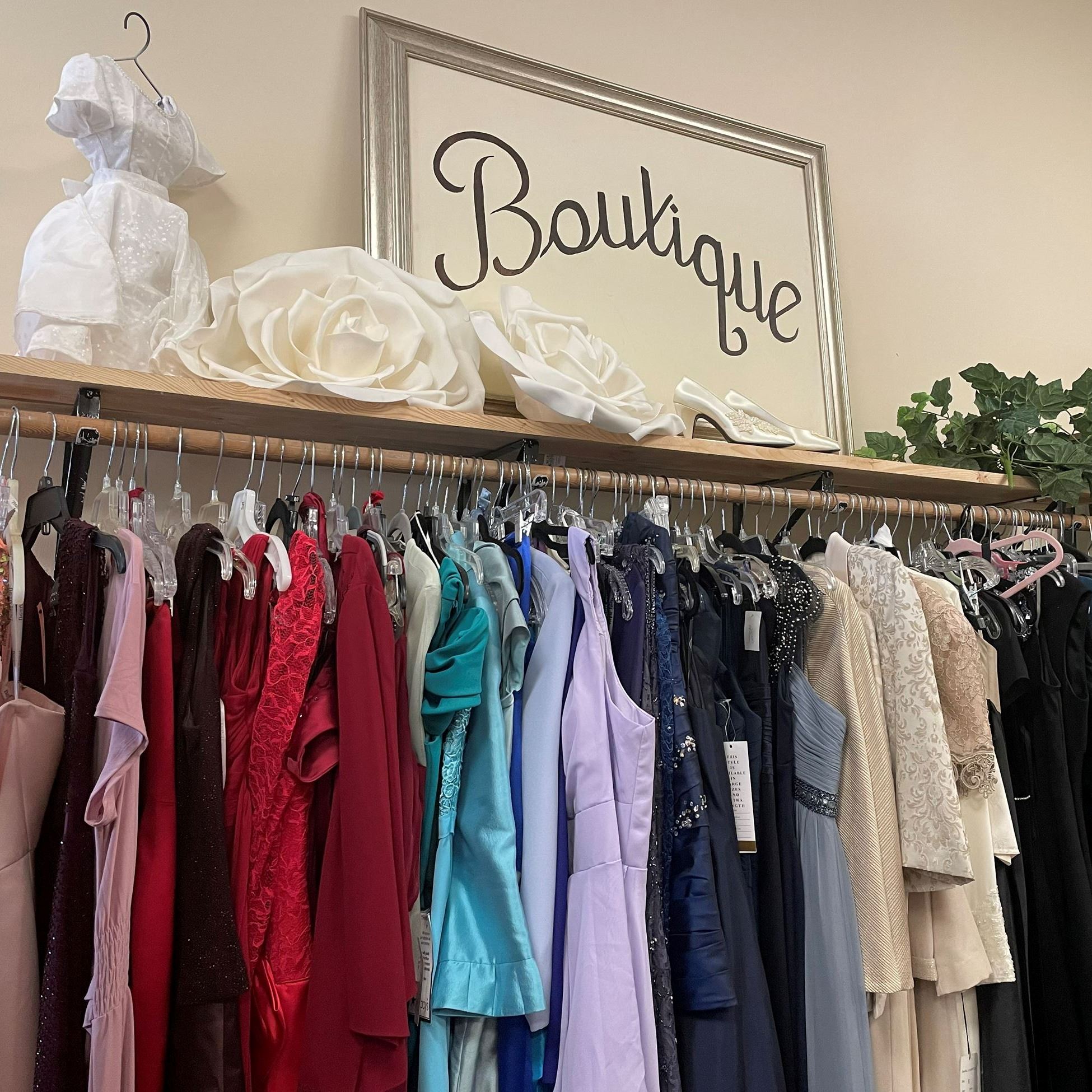 rack of dresses under a boutique sign