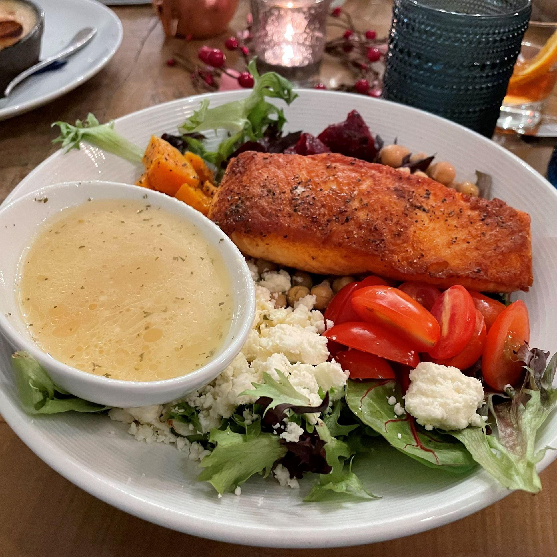 Salmon salad with dressing on a white plate